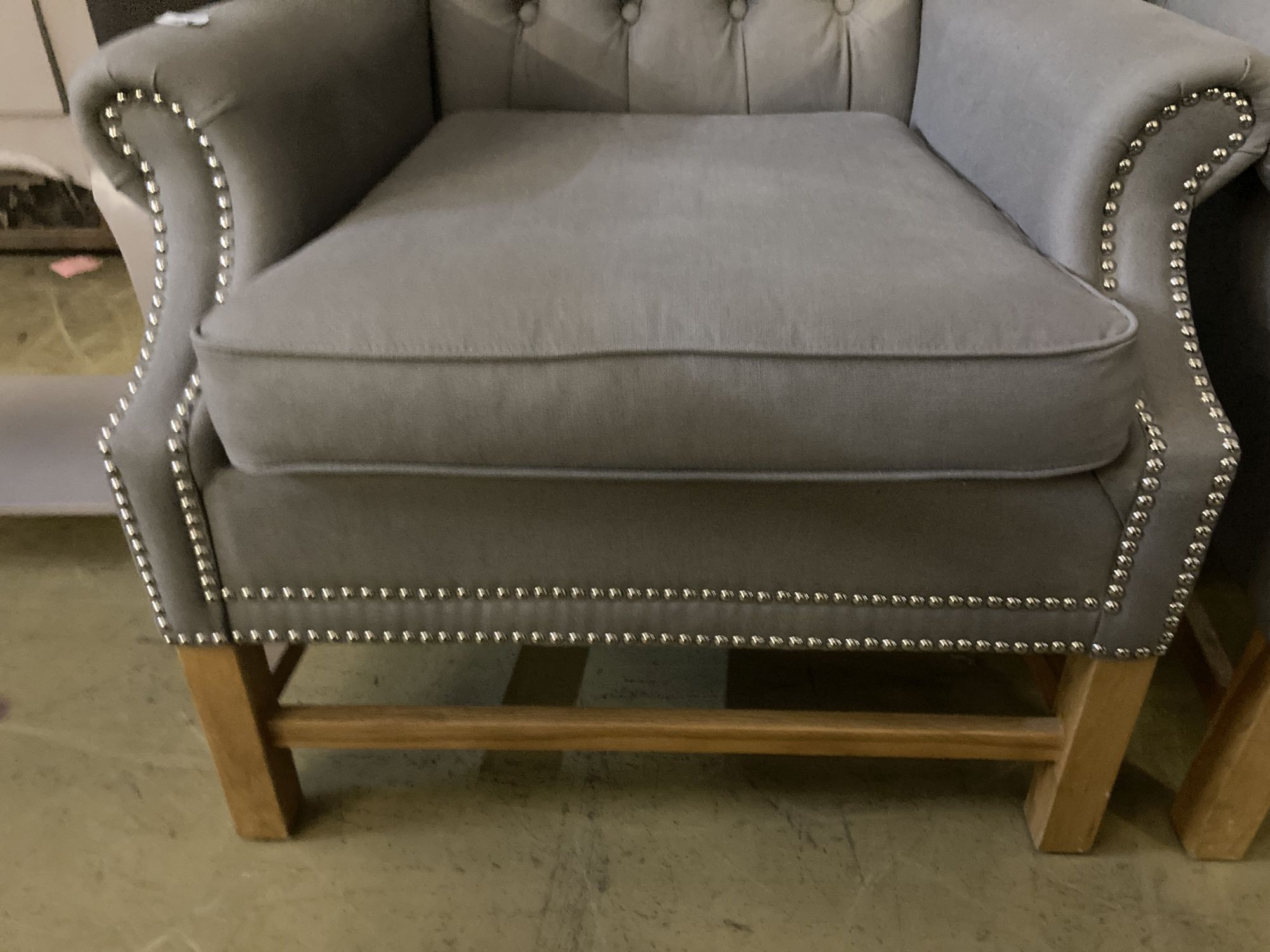 A pair of Victorian style wing armchairs, recently re-upholstered in buttoned grey fabric, width 82cm depth 78cm height 116cm